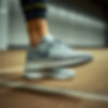 Nike Grey Sneakers in Athletic Setting A person showcasing Nike grey sneakers in an athletic setting