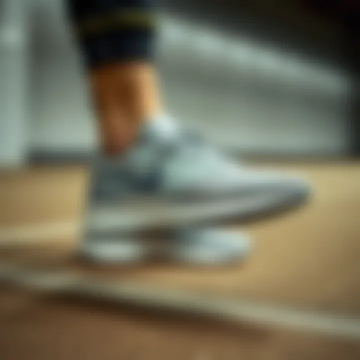 Nike Grey Sneakers in Athletic Setting A person showcasing Nike grey sneakers in an athletic setting